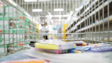 shopping wagon cart moving through store. Purchase of stationery for school. - Powered by Adobe