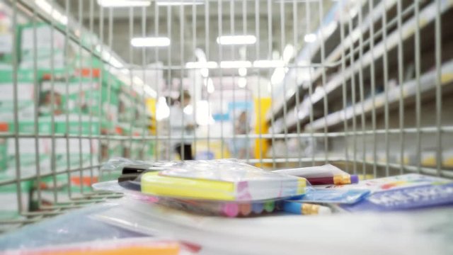 shopping wagon cart moving through store. Purchase of stationery for school.