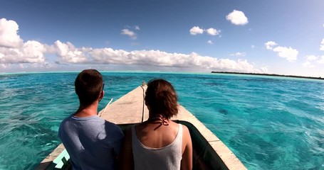 a couple in a boat on a lagoon in French Polynesia