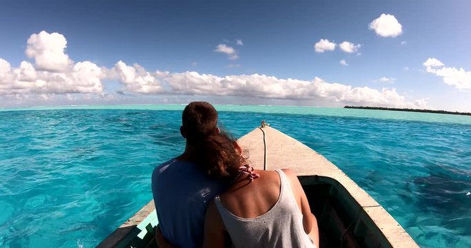 a couple in a boat on a lagoon in French Polynesia
