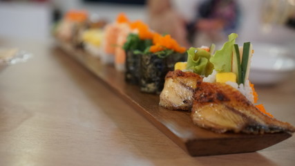 Close-up to selective at the front of japanese sushi rolls dish.