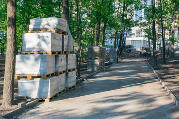 Stack of paving slabs in the sun. Preparing for installation work.