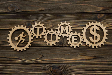 man, time, dollar, gears on a wooden background.concept of working time. making money.