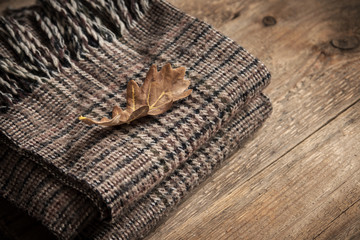 Autumn. Checkered plaid with dry leaf