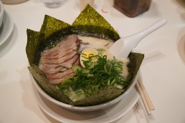 Ramen in big bowl on the white table, take a photo before eating, Foodstagramming