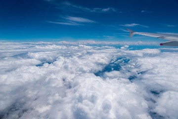 view of cumulus clouds from an airplane