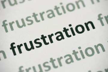 word frustration printed on paper macro