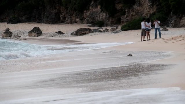 Tourists picture taking in a beach near the shore in Batanes, Philippines