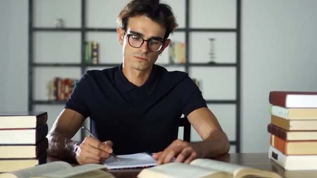 Successful college student Studying and writting in the notebook. Education, knowledge, school concept