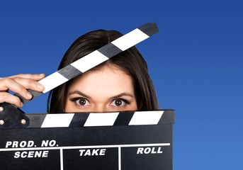Young woman with movie clapper