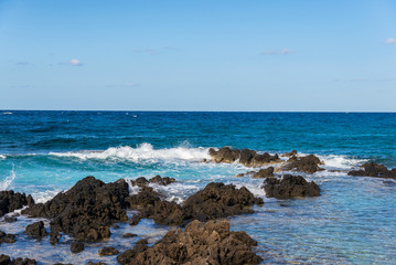 sea wave crashing on rocks