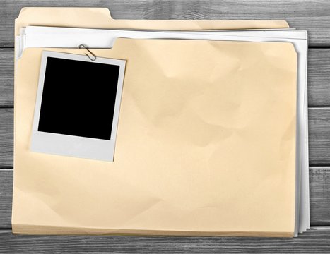 File Folder with Documents and Blank Polaroid