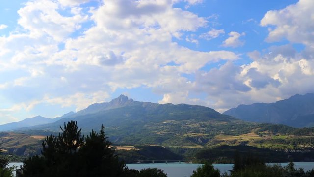 Time lapse of clouds passing by at a mountain lake in the French Alps. Shot with a Canon 80D in Timelapse Mode. 
Location: Lake Serre Pon&ccedil;on (05 region), southeast France.