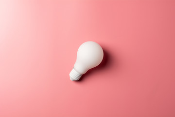 white classic light bulb on pink background. - for creative concept background.