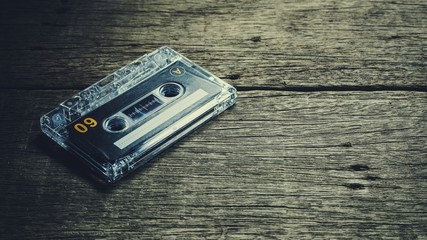 vintage audio cassette tapes on wooden background. - vintage backdrop style.
