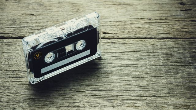 vintage audio cassette tapes on wooden background. - vintage backdrop style.