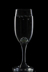 A glass for champagne with a glass ball and bubbles