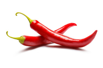 Two red chili peppers, isolated on white background