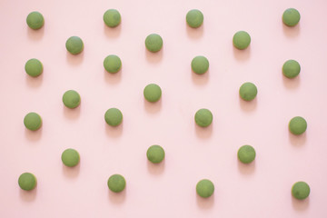 chlorella tablets on pink background