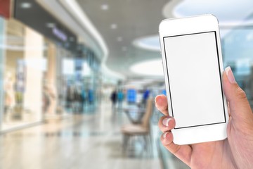 Hand holding smartphone on blurred background