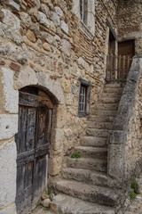 Fototapeta na wymiar Carved Worn Steps in the Ancient Preserved Village of Perouges, France