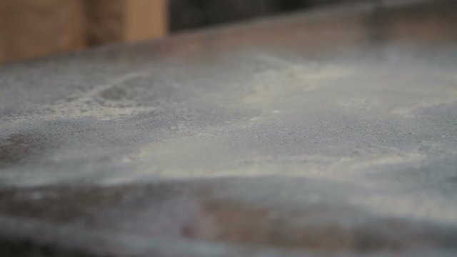 Baking background with flour on a metal table