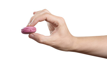 Hand holding a pink macaroon, isolated on white background