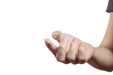 Male index finger holding contact lens, isolated on white background