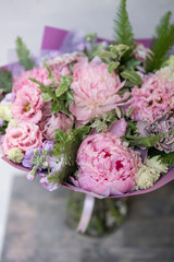 Work florist. Beautiful spring bouquet. Arrangement with mix flowers. The concept of a flower shop, a small family business. Pastel Color.