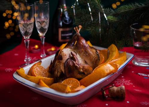Grilled guinea-fowl with mandarins in white form for cooking with New Year's details