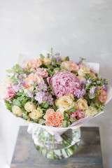 Obraz na płótnie Canvas Beautiful spring bouquet. Arrangement with mix flowers. The concept of a flower shop, a small family business. Color light pink and lilac.