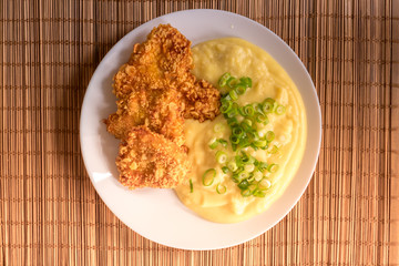 Chicken schnitzel with mashed potatoes on the plate.