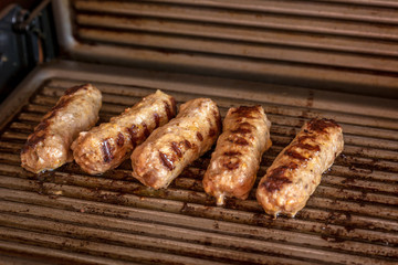 Cevapcici baked on the grill. Small sausages from minced meat, a very popular dish in the Balkan...