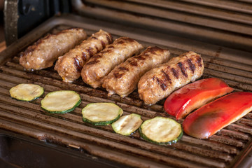 Cevapcici baked on the grill. Small sausages from minced meat, a very popular dish in the Balkan countries.