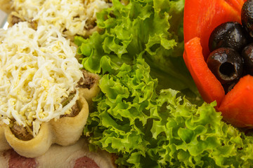 Ornaments from pepper and olives with greens, close-up.