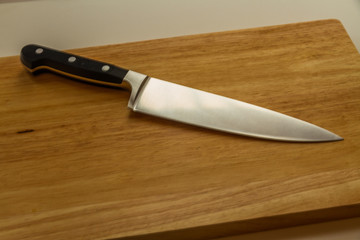 Cook’s knife on chopping board