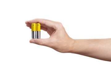 Male hand holding yellow AA batteries, isolated on white background