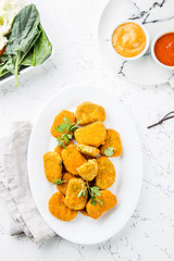 Healthy vegetarian nuggets with carrots, cauliflower and spinach. Vegetable nuggets. Vegan food. Top view, white background