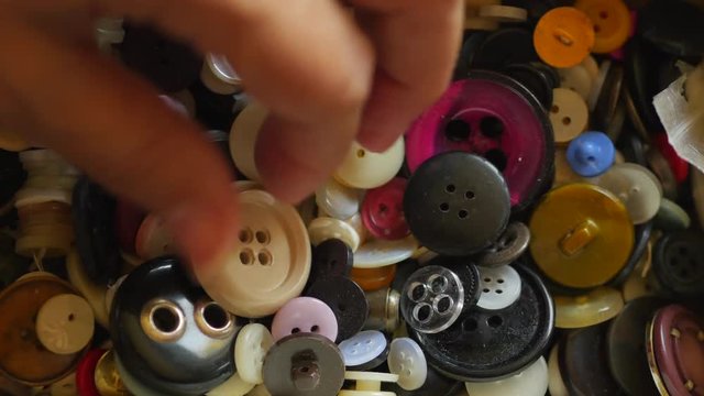 Sewing Buttons In Female Hand