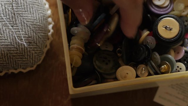 Sewing Buttons In Female Hand