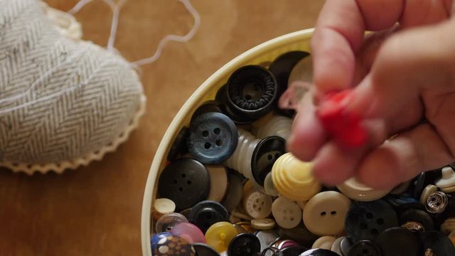 Sewing Buttons In Female Hand