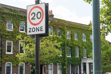 20 mph speed limit sign on public road, driving safety