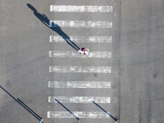 top aerial view of on man walking on the crosswalk in the street, abstract isolated disign with...