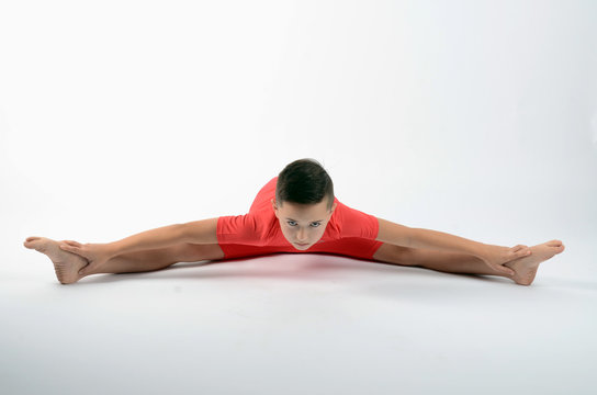 Male child gymnast performing the splits