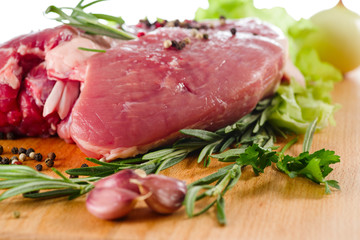 pork closeup on a board with salad and meat for cooking, selective focus