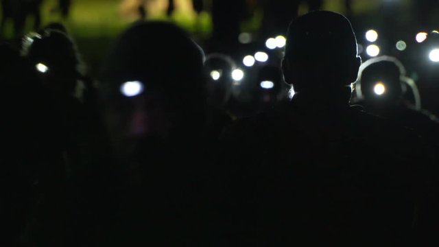 Triathlon in the dark, head torches, running.