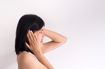 Fototapeta premium Asian woman on a white background holding her sick ear,Tinnitus