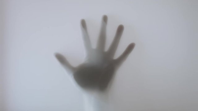 The hand fall on a glass window.