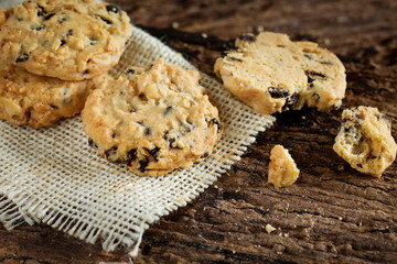 Pile of chocolate chip cookies on sackcloth.