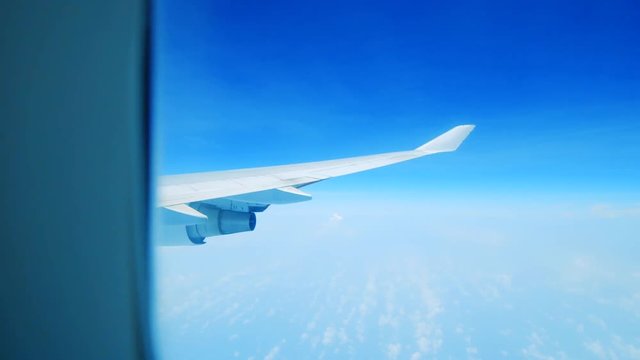 Reveal of plane wing and engine from interior window